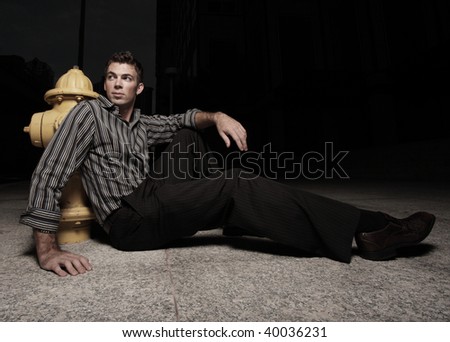 Man sitting by a fire hydrant