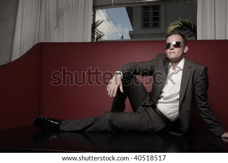 Businessman in a suit sitting on a table