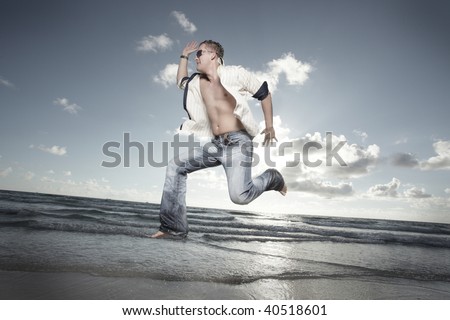 Man in a midair jump on the beach