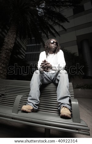 Man sitting on a bus stop bench