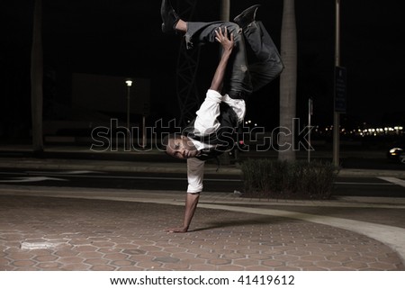 Dancing man performing a handstand