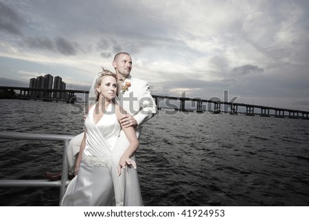Attractive young bride and groom posing for photos after the wedding ceremony.  Image part of wedding series 1