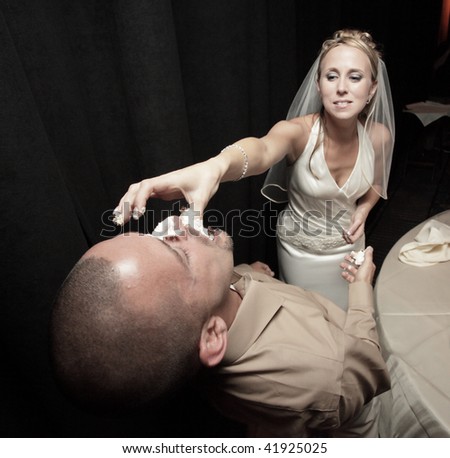 Bride feeding the groom cake.  Image part of wedding series 1