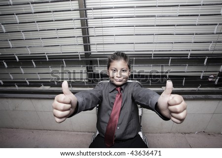 Young boy displaying thumbs up