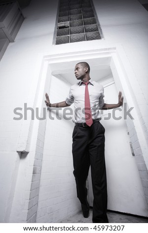 Unusual angle of a young African American male on a doorway