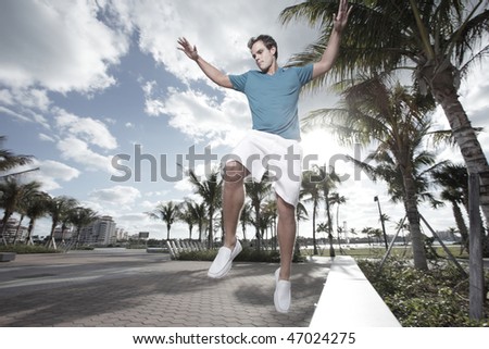 Man jumping of a park bench
