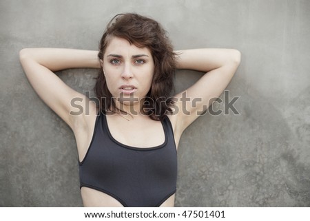 Woman with arms behind her head