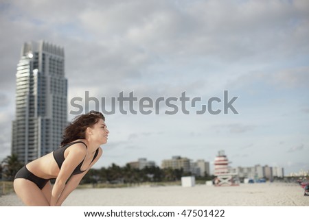 Woman on the beach looking to the right which can be used as copyspace