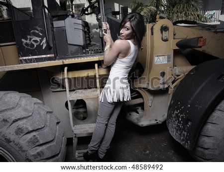 Woman posing on industrial machinery
