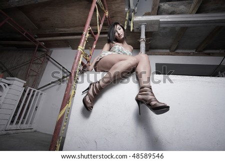 Woman sitting on a ledge at night