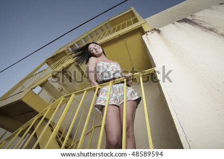 Unusual angle of a woman posing on a staircase