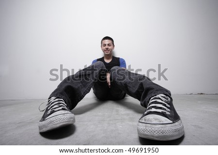 Unusual angle of a young man sitting