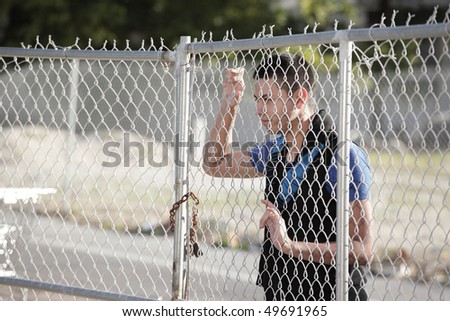 Man looking through the fence