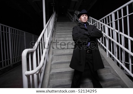 Man in a trench coat on a staircase