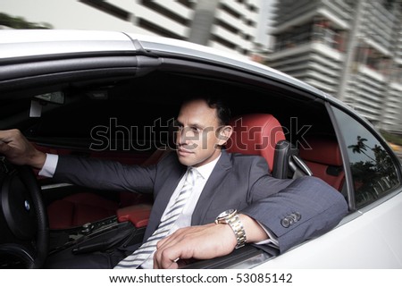 Businessman driving in his luxury automobile