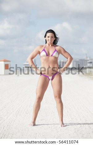 Attractive fitness model flexing her body