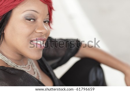 Young black woman sitting and smiling