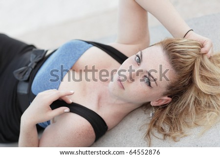 Woman laying down and looking at the camera