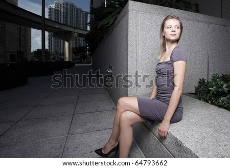 Woman sitting on a ledge in the dark