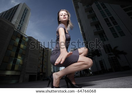 Woman squatting and reaching for the ground