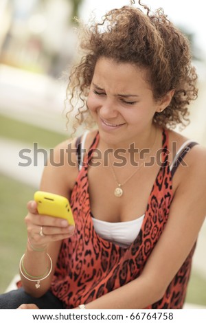 Woman reading a text and smirking
