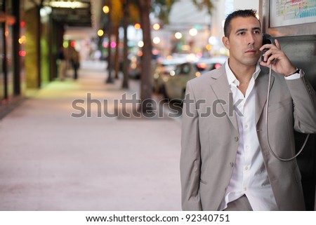 Businessman using a pay phone