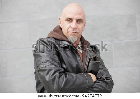 Tough bald man with a leather jacket