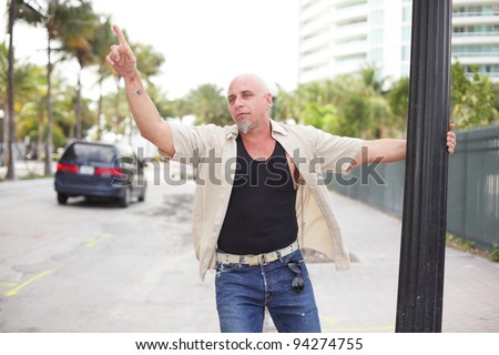 Drunk man waving at cars passing by