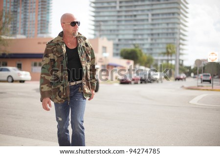 Tough man walking down the street