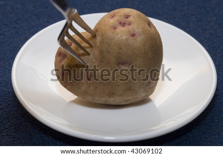 Root of potato in the form of heart rests on a plate