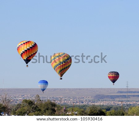 Hot air balloons floating over the desert