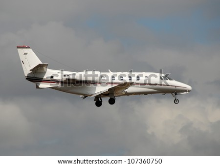 Corporate jet airplane side view preparing for landing