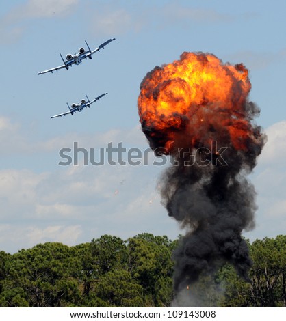 Modern military jetfighters performing target bomb raid