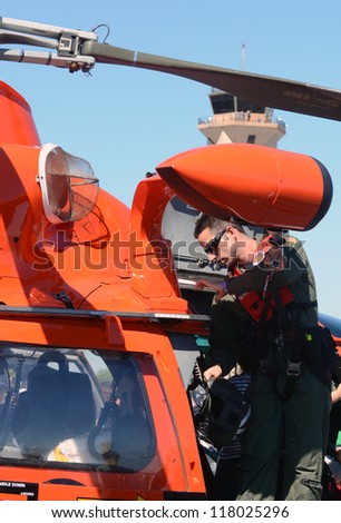 MIAMI - NOVEMBER 3: US Coast Guard pilot prepares his helicopter for flight on November 3, 2012 at Opa Locka airport in Miami, Florida