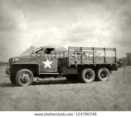 World War II era military truck at a camp