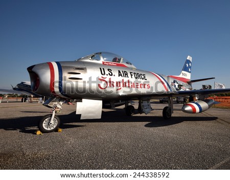 STUART - NOVEMBER 1: Korean War era F-86 Sabre jetfighter stops over in Stuart, Florida on the way to an airshow on November 1, 2014. The jet is fully restored and painted in promotional color scheme.