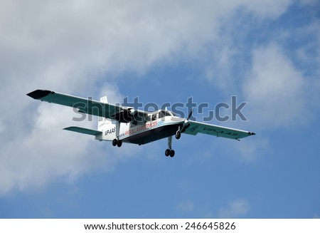 PHILIPSBURG - DECEMBER 24: Anguilla Air Services turboprop airplane arrives in Philipsburg, Saint Maarten in the Caribbean. The airline connects the small island with neighboring airports.