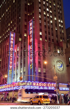 NEW YORK - APRIL 27: Night traffic speeds past landmark Radio City Music Hall in New York City on April 27, 2015. The venue is legendary in entertainment industry