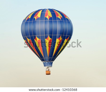 Colorful hot air balloon taking off at dawn
