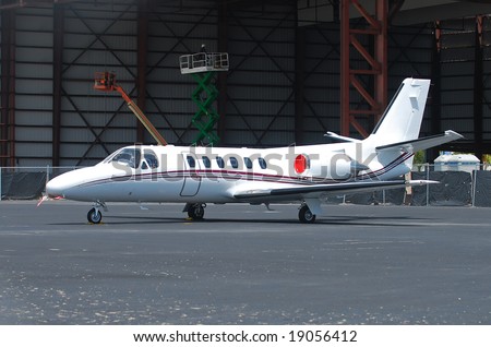 Luxury charter jet plane parked near hangar