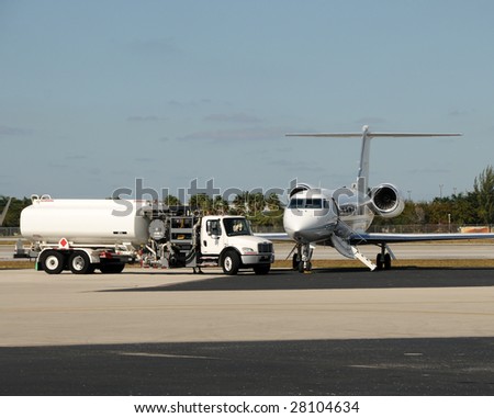 Modern business jet on a tarmac for fueling