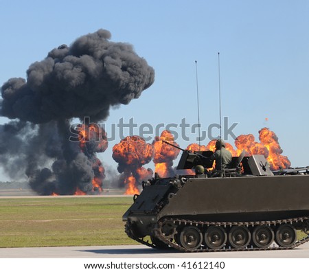 Armored vehicle in ground battle with explosions ans smoke
