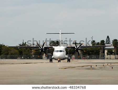 Turboprop airplane on the ground front view