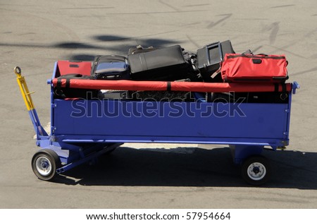 Bags loaded onto airport baggage cart for transfer