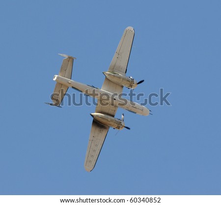 World War II era bomber flying overhead