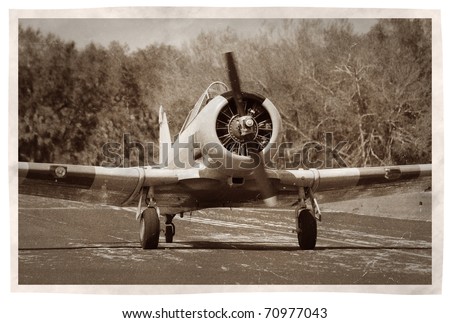 World War II era propeller airplane on faded photo