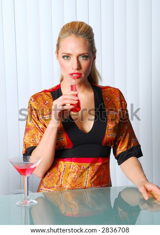 Blond model at bar with red drink