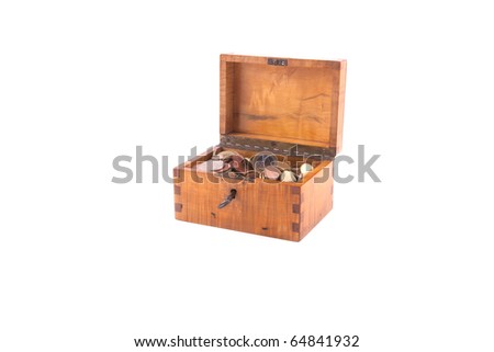 Antique handcrafted wooden money box with small money isolated on a white background