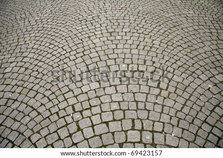 Old grey pavement in a pattern in an old medieval european town.