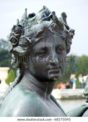 Bronze statue of woman in Versailles Chateau gardens. France